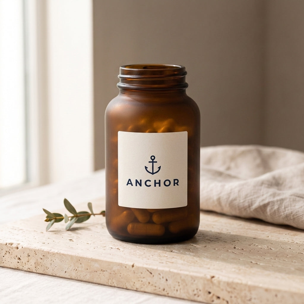 Anchor GLP-1 Support Complex navy tub on travertine stone with eucalyptus, natural window light